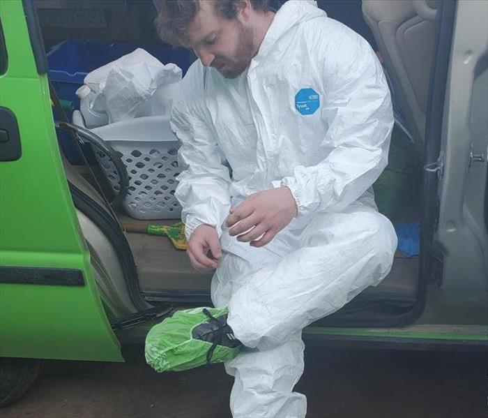 Employee suiting up in PPE for a covid19 cleaning