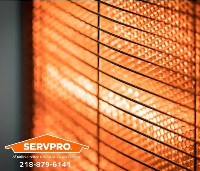 Heated coils radiate heat on a home's wall heater.