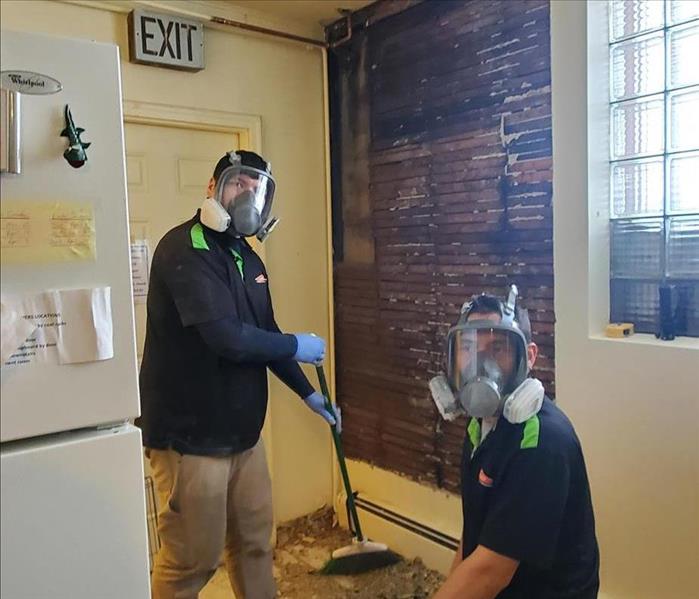 SERVPRO crew assisting with damages from a water pipe burst.