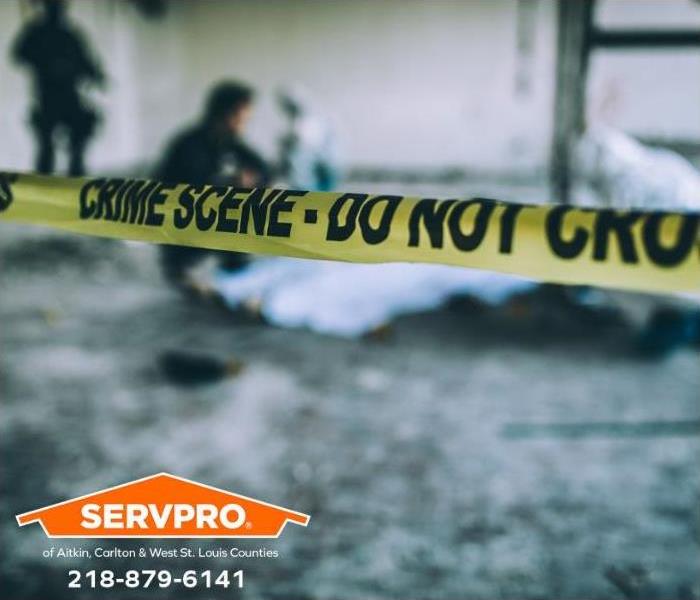 Crime scene tape borders an active crime scene investigation.