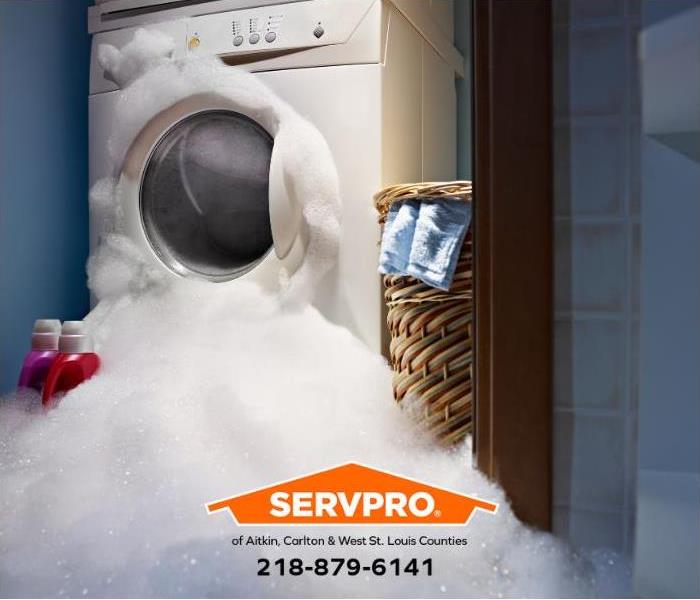 A washing machine is leaking suds and flooding a laundry room.