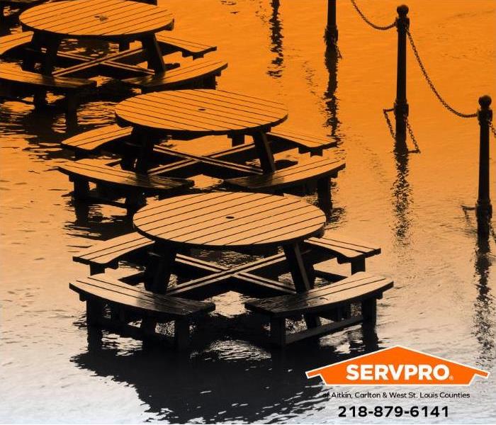 The outdoor seating area of a business is flooded.